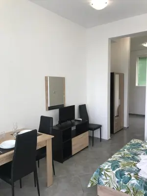 a bedroom with a bed and a table and chairs at Villa Maria 2 in Chernomorets