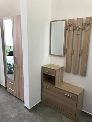 a mirror and a wooden dresser in a room at Villa Maria 2 in Chernomorets