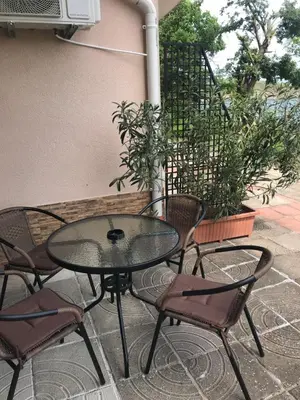 a glass table and chairs on a patio at Villa Maria 2 in Chernomorets