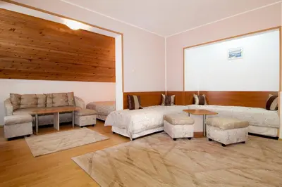 a living room with a couch and a table at Hotel Tropics & Venera - Ultra All Inclusive in Sveti Vlas