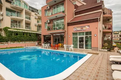 a swimming pool in front of a building at Hotel Tropics & Venera - Ultra All Inclusive in Sveti Vlas