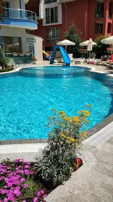 a swimming pool with a slide in a hotel at Blue Bay Hotel in Sunny Beach