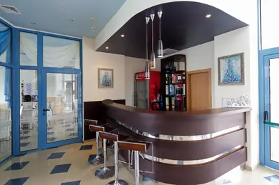 a bar in a restaurant with stools at Blue Bay Hotel in Sunny Beach