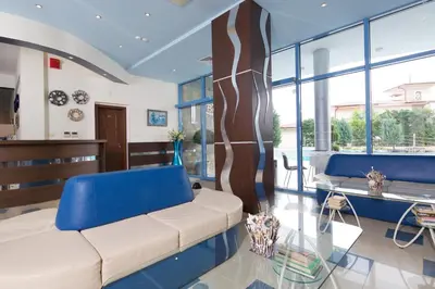 a living room with a couch and a table at Blue Bay Hotel in Sunny Beach