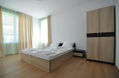 a bedroom with a bed and a large window at Guest House ASK in Primorsko