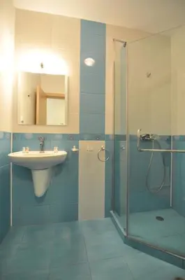 a bathroom with a shower and a sink and a showerspective at Guest House ASK in Primorsko