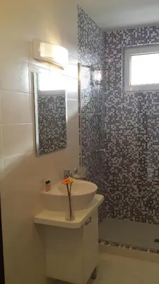 a bathroom with a sink and a shower at Guest House ASK in Primorsko