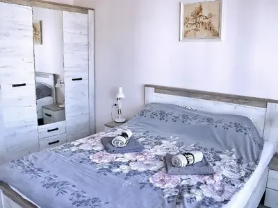 a bedroom with a bed with two towels and a mirror at Venum in Varna City