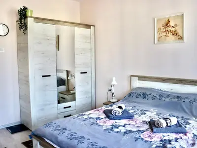a bedroom with a bed and a large mirror at Venum in Varna City