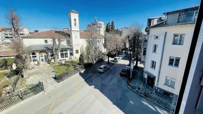 a view of a city street with a clock tower at Venum in Varna City