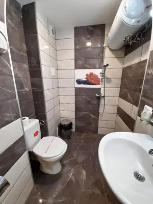 a bathroom with a toilet and a sink at Complex Strandzhata in Burgas City