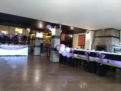 a room with purple balloons and a table with a bar at Complex Strandzhata in Burgas City