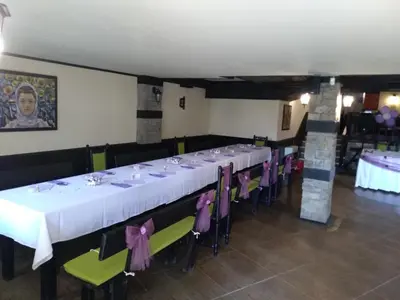 a dining room with a long table and chairs at Complex Strandzhata in Burgas City
