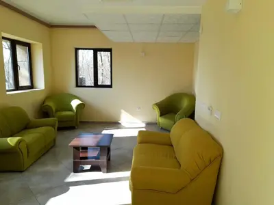 a waiting room with green chairs and a couch at Complex Strandzhata in Burgas City