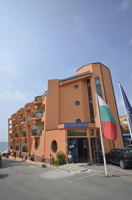 a building with a flag in front of it at Hotel Evridika in Nesebar