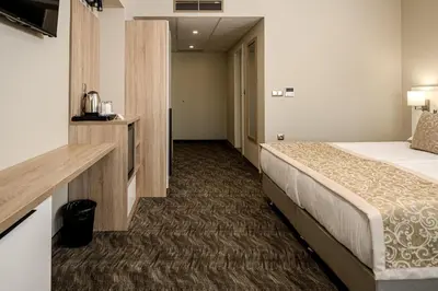 a hotel room with a bed and a hallway at Hotel Laguna Park Sunrise in Sunny Beach