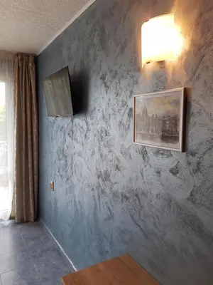 a room with a marble wall with a picture on it at Morska Zvezda Guest House in Chernomorets