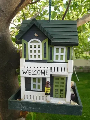 a small house with a welcome sign in a tree at Morska Zvezda Guest House in Chernomorets