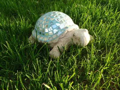 a stuffed turtle is sitting in the grass at Morska Zvezda Guest House in Chernomorets