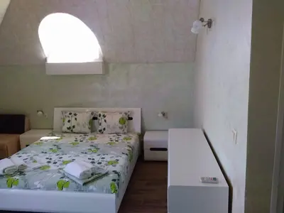 a small bedroom with a bed and a window at Morska Zvezda Guest House in Chernomorets