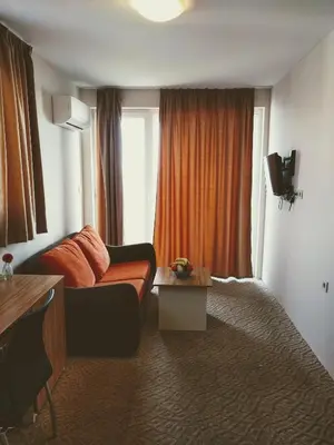 a hotel room with a couch and a window at Hotel Mida in Obzor