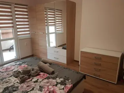 a bedroom with a bed and a dresser at Odessus in Varna City