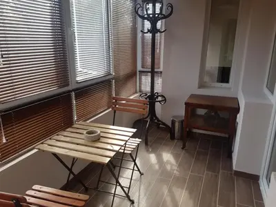 a room with a wooden table and chairs and a desk at Odessus in Varna City