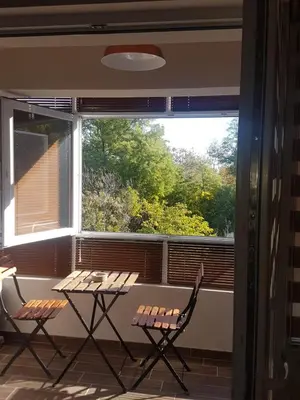 two chairs and a table in front of a window at Odessus in Varna City