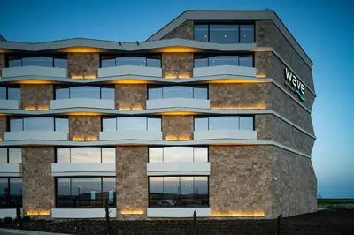 a building with lights on the side of it at Wave Resort - Ultra All Inclusive in Pomorie