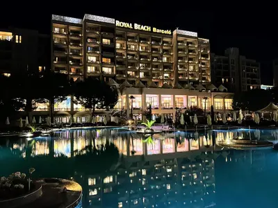 a hotel with a swimming pool at night at Royal Beach Premium in Sunny Beach