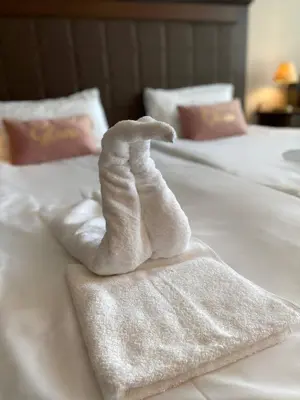 a white towel on top of a bed at Royal Beach Premium in Sunny Beach