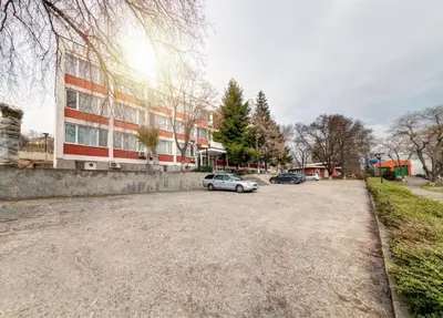 a parking lot with a car parked in front of a building at Hotel Varly Bryag in Burgas City