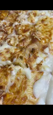 a close up of a pizza with cheese at Hotel Arsenal in Nesebar