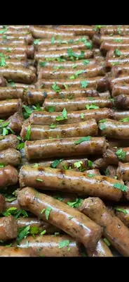 a bunch of sausages sitting on top of a grill at Hotel Arsenal in Nesebar