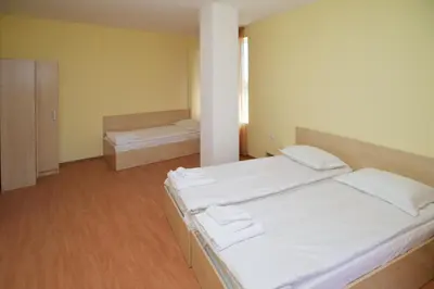 a large room with two beds in it at Aparthotel Anixi in Obzor