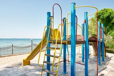 a playground on the beach with a slide at Messambria Beach Apartments in Sveti Vlas