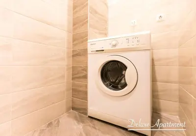 a washer and dryer in a laundry room at Apartment Cathedral Deluxe in Varna City