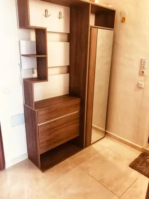 a kitchen with a wooden cabinet and a refrigerator at Vista Sul Mare in Burgas City