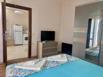 a room with a bed and a tv and a mirror at Vista Sul Mare in Burgas City
