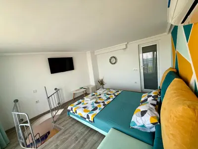 a bedroom with a bed and a flat screen tv at Vista Sul Mare in Burgas City