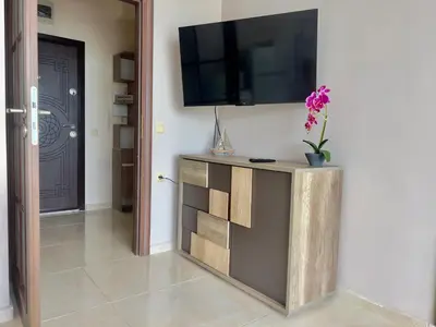 a living room with a television on a wall at Vista Sul Mare in Burgas City