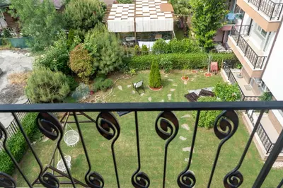 a view of a garden from a balcony at Dion Apartments in Lozenets