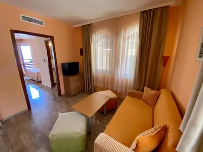 a living room with a couch and a television at Family Hotel Saint Nikola in Nesebar
