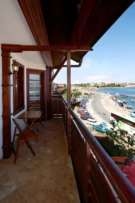 a balcony of a building with a view of a beach at Family Hotel Saint Nikola in Nesebar