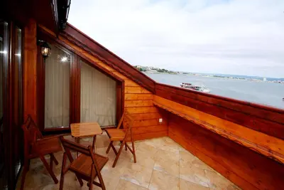 a balcony with chairs and a view of the water at Family Hotel Saint Nikola in Nesebar