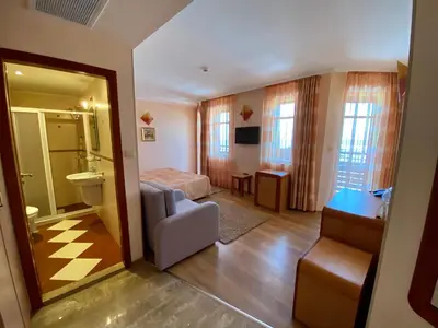 a hotel room with a bed and a bathroom at Family Hotel Saint Nikola in Nesebar