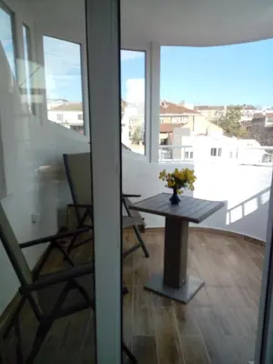 a room with a table and chairs on a balcony at Studio Lilou in Varna City