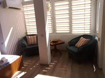 a living room with two chairs and a table at Studio Lilou in Varna City