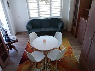 a living room with a table and chairs and a couch at Studio Lilou in Varna City