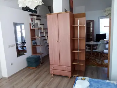 a room with a large pink cabinet and a table at Studio Lilou in Varna City